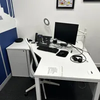 Corner office desk with chair and with meeting room table and 4 chairs