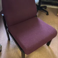 A sturdy office task chair upholstered in burgundy fabric