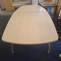 Light oak extending dining/meeting table with curved ends